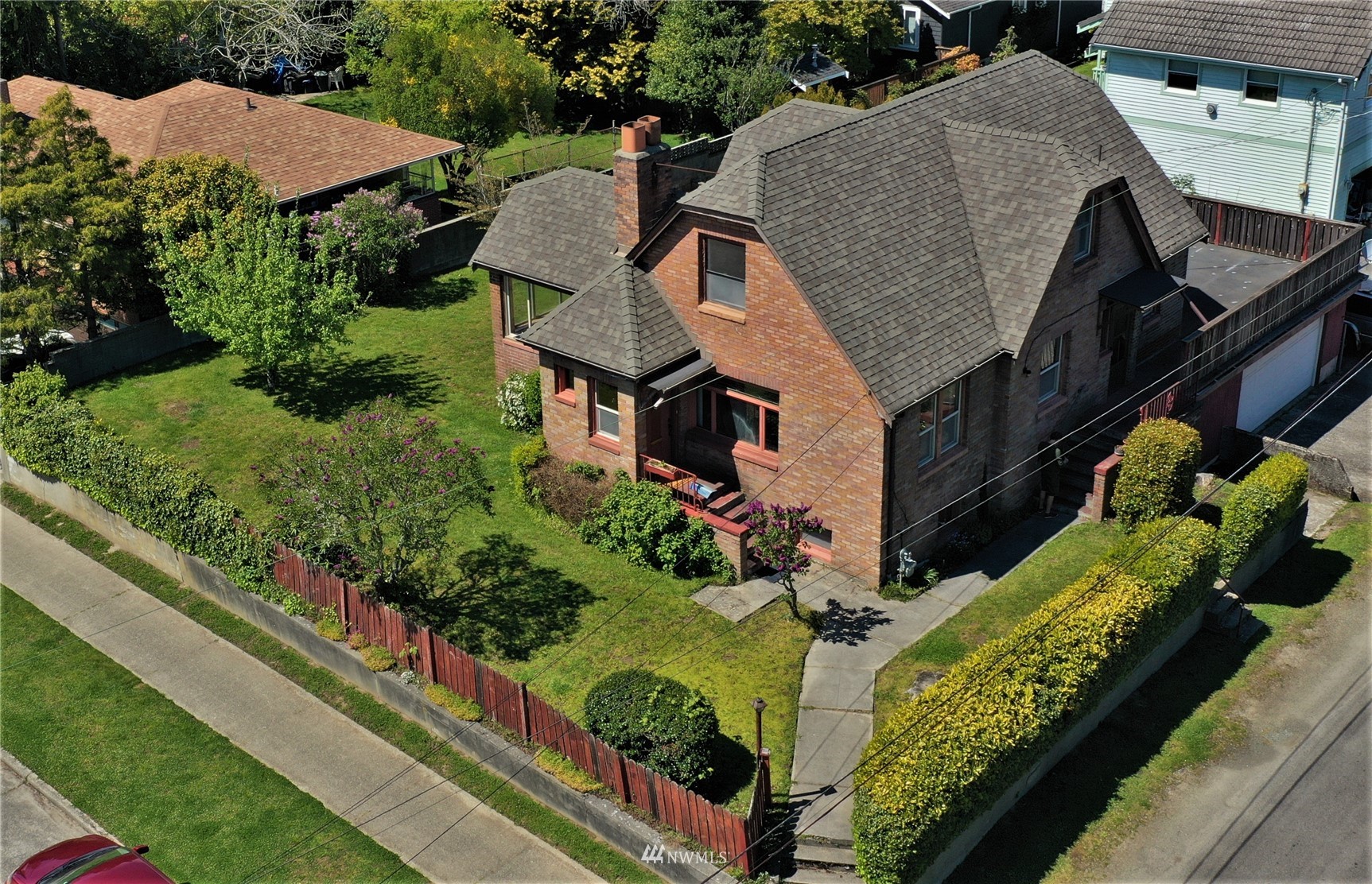 a aerial view of a house with large trees