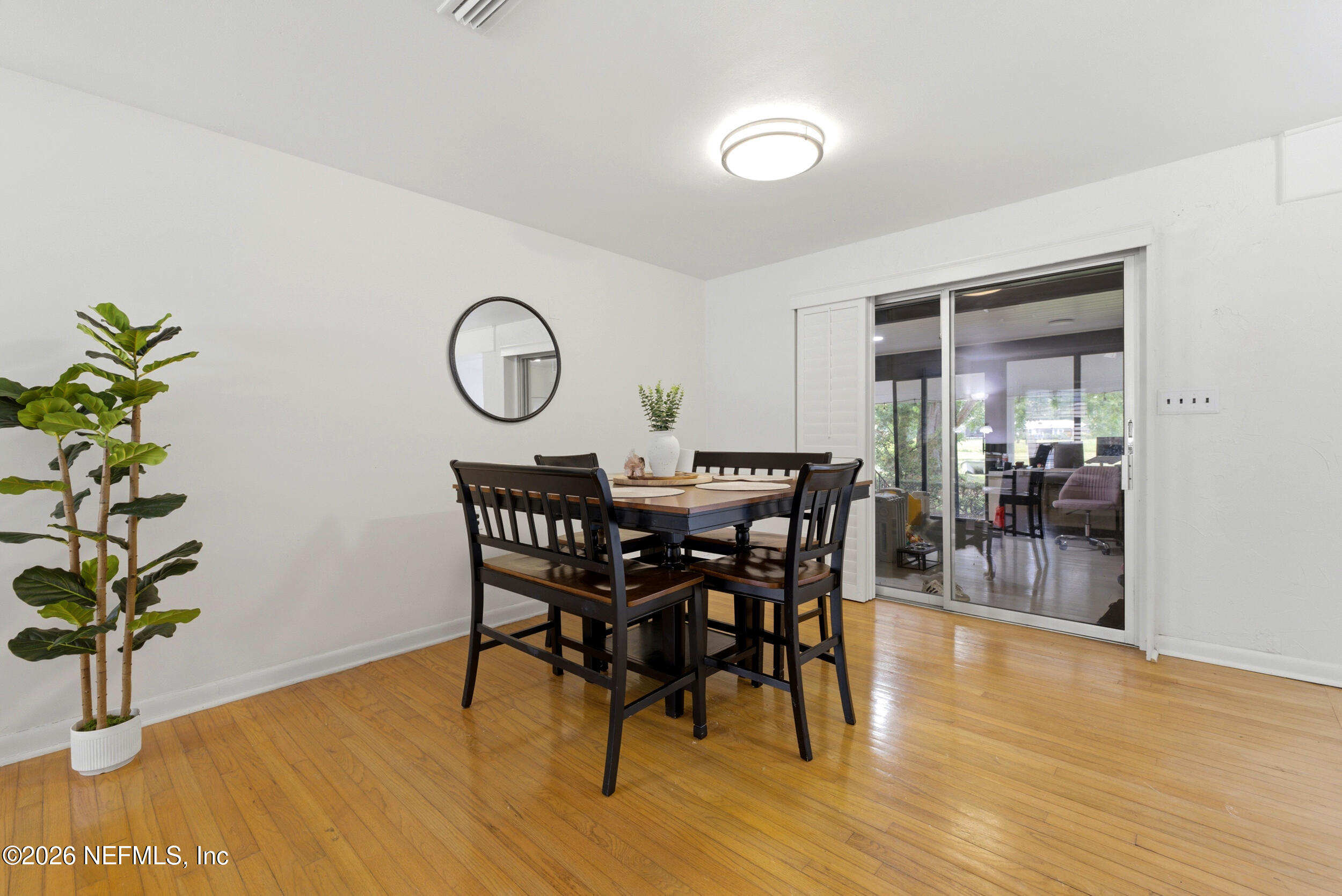 7484 Spinola Road Jacksonville, FL 32217 - Photo 14 of 63 a view of a dining room with furniture and wooden floor
