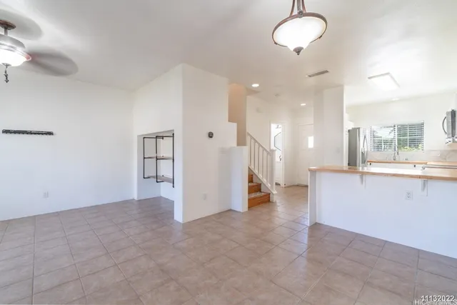 a kitchen with stainless steel appliances granite countertop a sink and a refrigerator