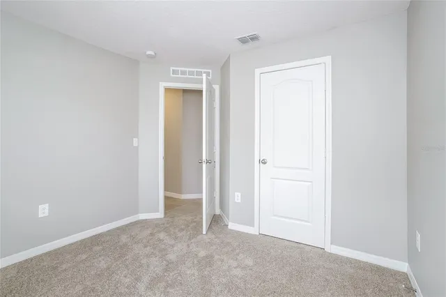 an empty room with closet area