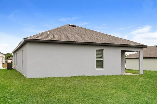 a view of a house with a backyard