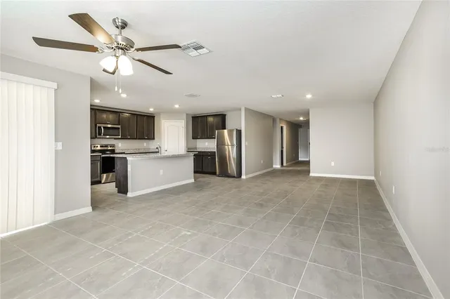 a view of a kitchen with a sink and stainless steel appliances