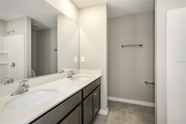 a bathroom with a double vanity sink and a mirror