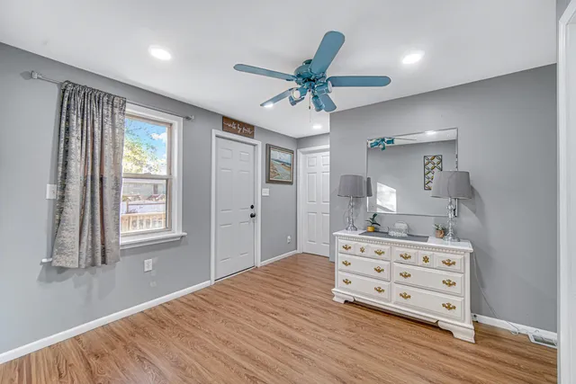 a room with a dresser and a window