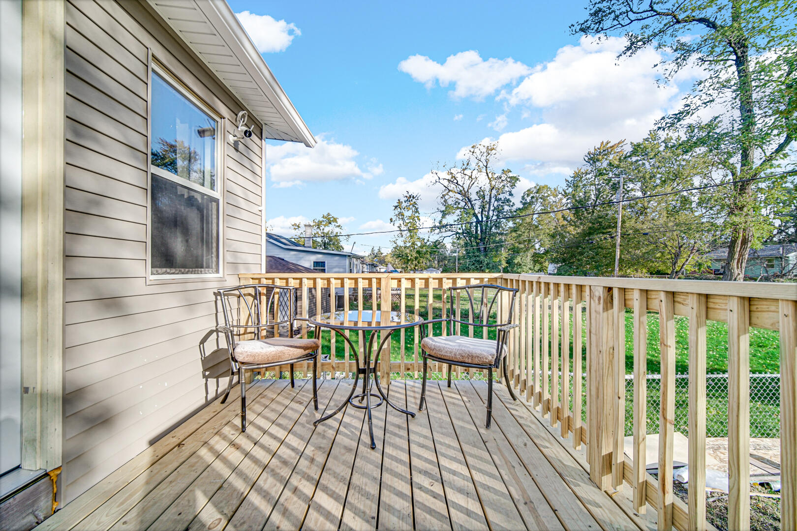 1047 Ralston Street Gary, IN 46406 - Photo 15 of 16 a balcony with wooden floor table and chairs