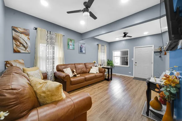 a living room with furniture and wooden floor