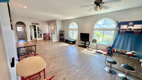a view of a livingroom with furniture workspace and a mirror