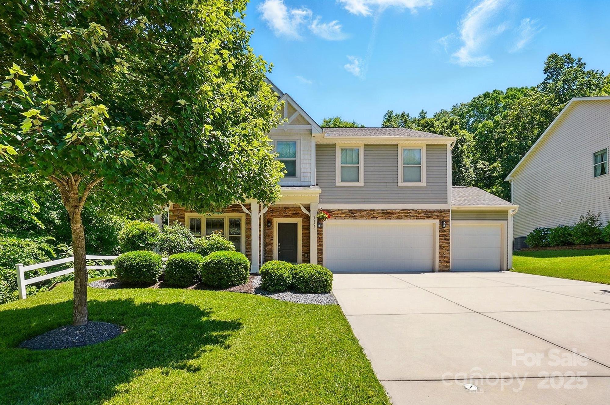 3106 Crosswind Drive Fort Mill, SC 29707 - Photo 1 of 43 a front view of a house with a yard and potted plants
