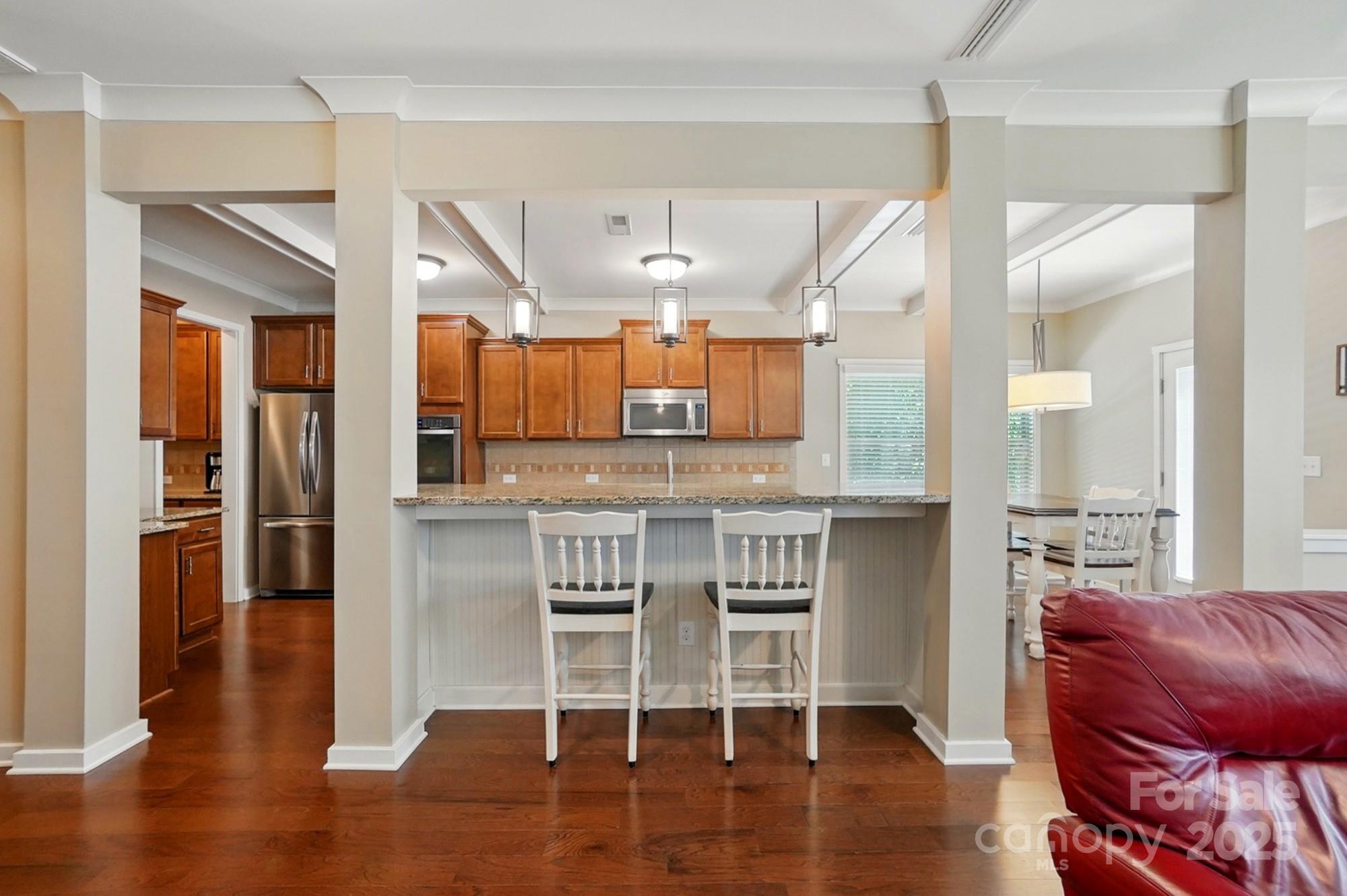 3106 Crosswind Drive Fort Mill, SC 29707 - Photo 17 of 43 a living room with stainless steel appliances kitchen island granite countertop furniture and wooden floor