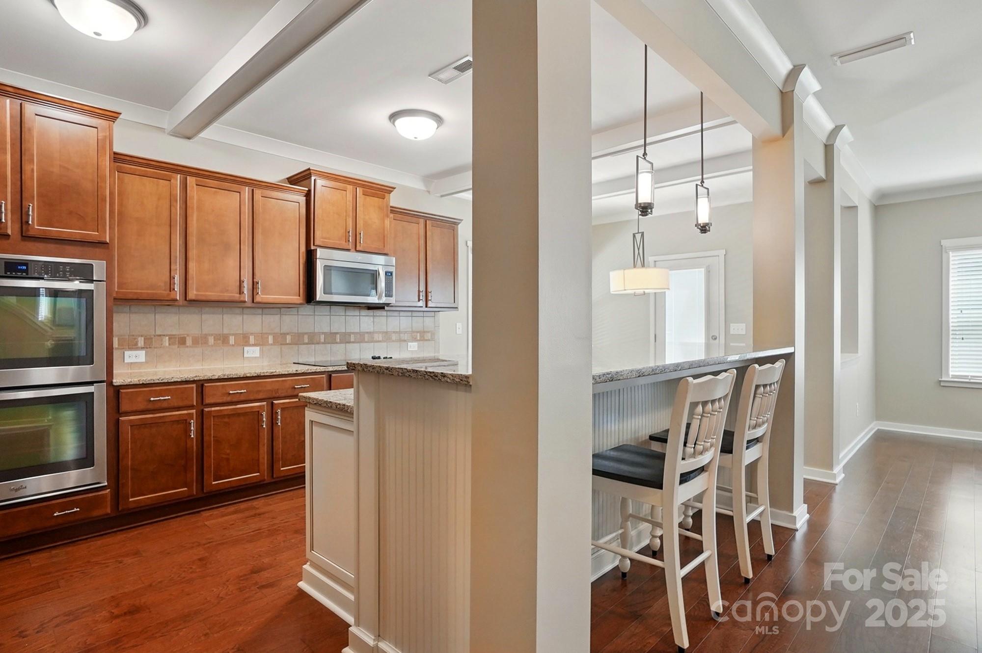 3106 Crosswind Drive Fort Mill, SC 29707 - Photo 19 of 43 a kitchen with stainless steel appliances granite countertop a refrigerator and a stove top oven