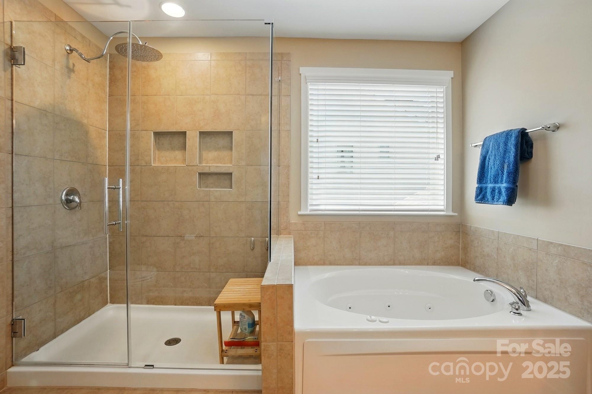3106 Crosswind Drive Fort Mill, SC 29707 - Photo 29 of 43 a bathroom with a bathtub and a shower