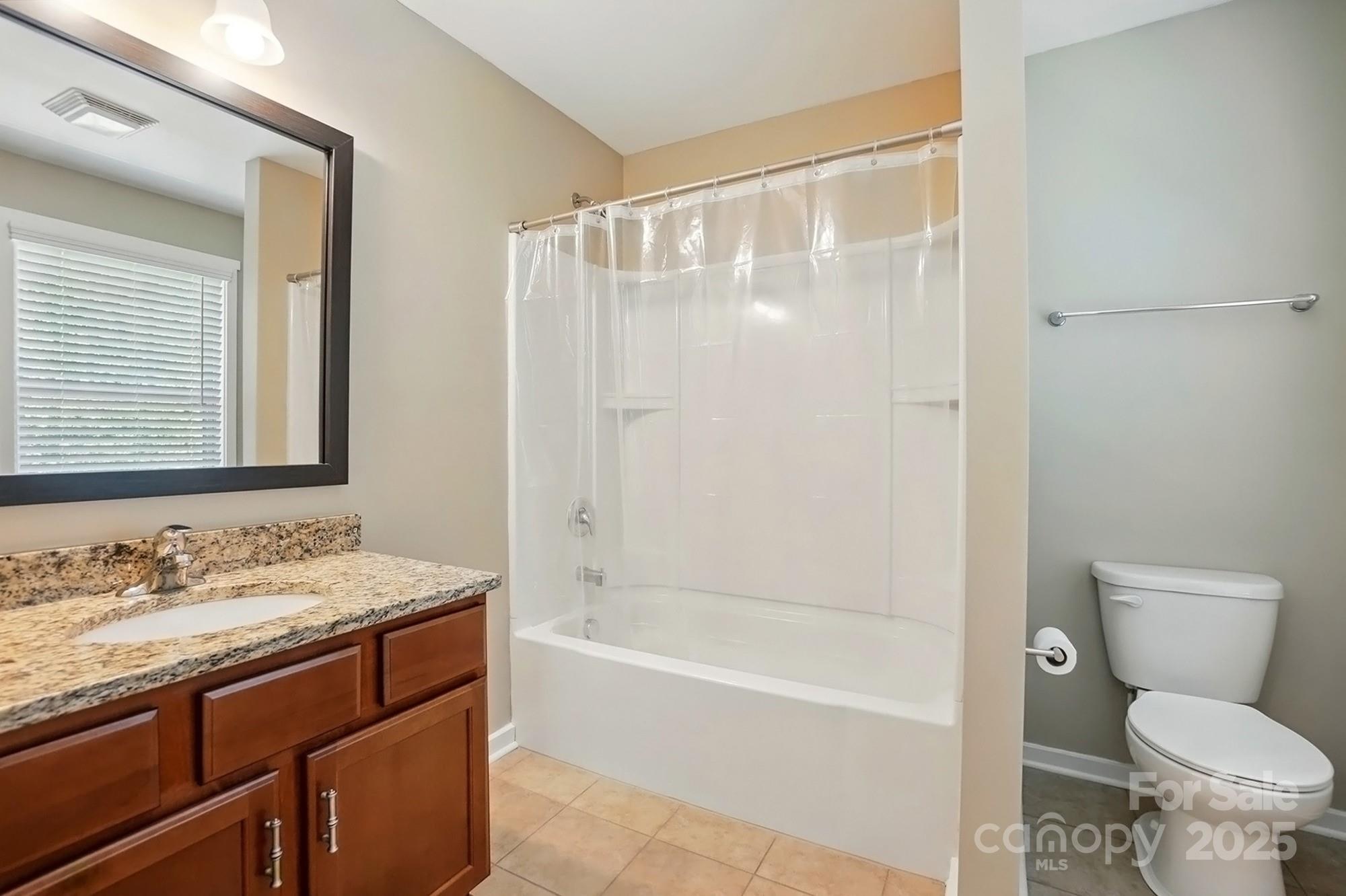 3106 Crosswind Drive Fort Mill, SC 29707 - Photo 31 of 43 a bathroom with a granite countertop sink toilet and shower