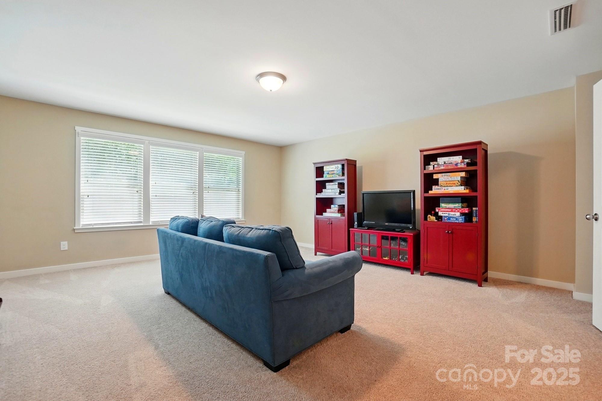 3106 Crosswind Drive Fort Mill, SC 29707 - Photo 34 of 43 a living room with furniture and a flat screen tv