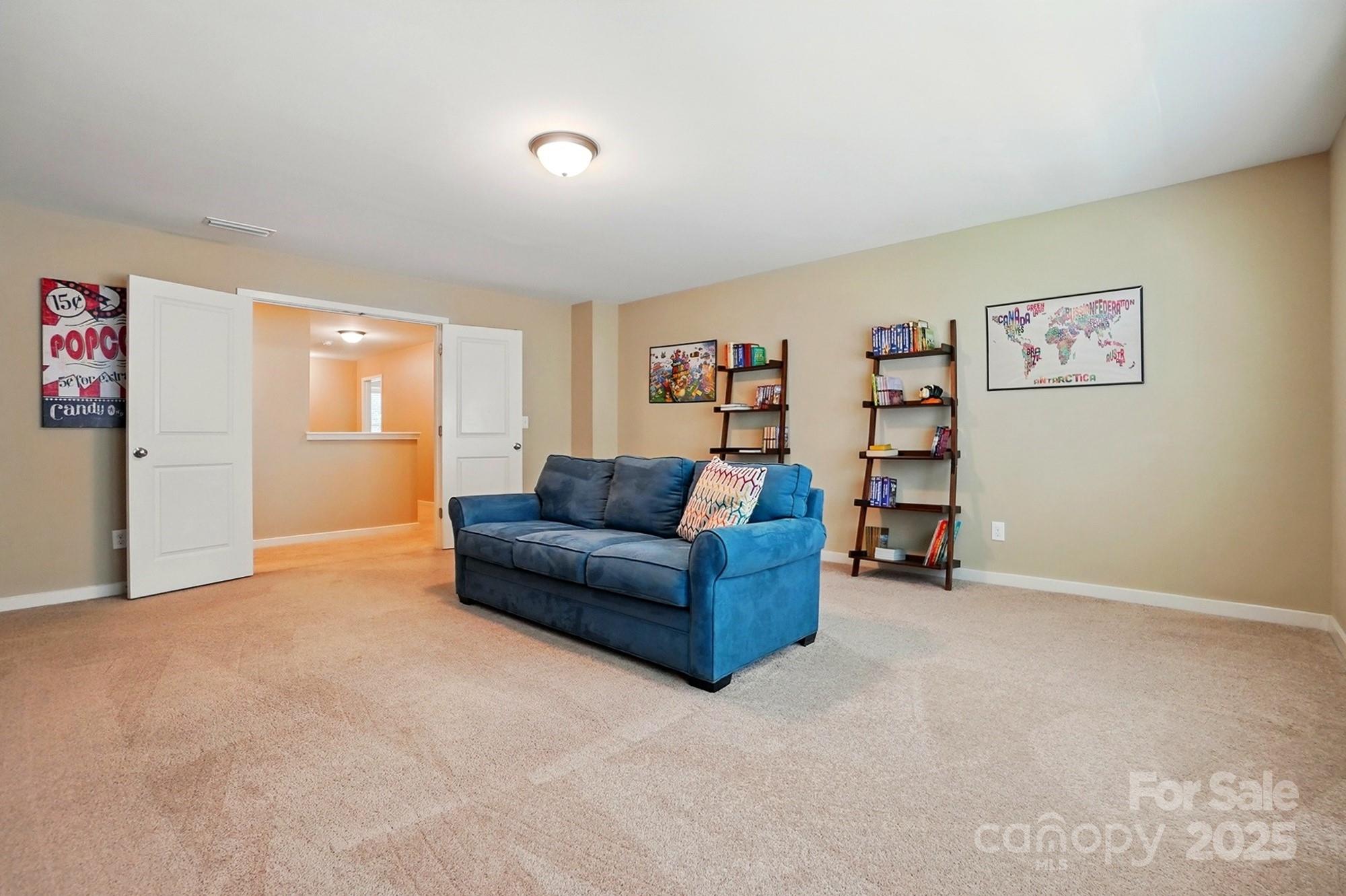 3106 Crosswind Drive Fort Mill, SC 29707 - Photo 35 of 43 a living room with furniture and a bookshelf