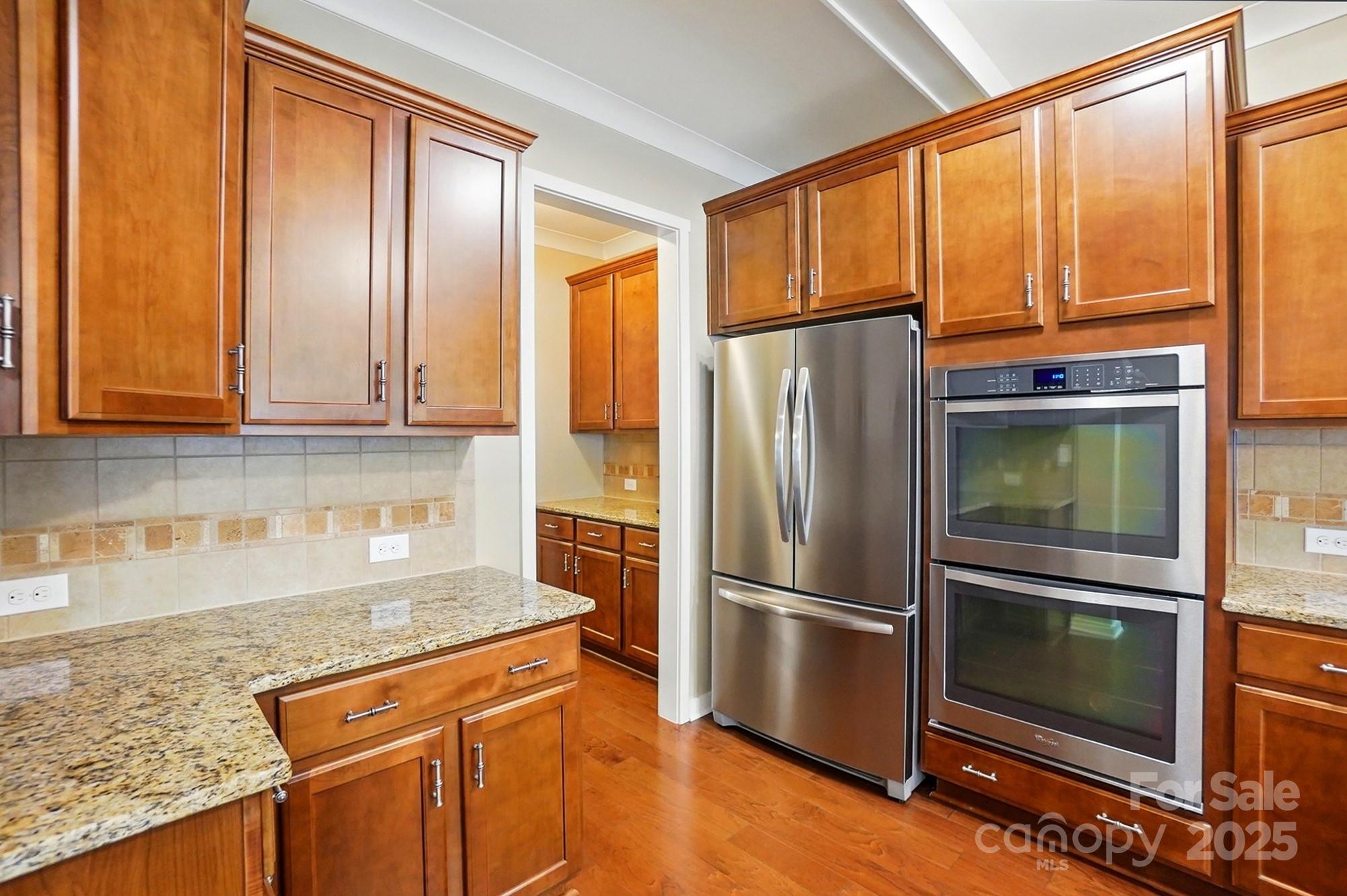 3106 Crosswind Drive Fort Mill, SC 29707 - Photo 5 of 43 a kitchen with granite countertop stainless steel appliances a refrigerator microwave and stove top oven