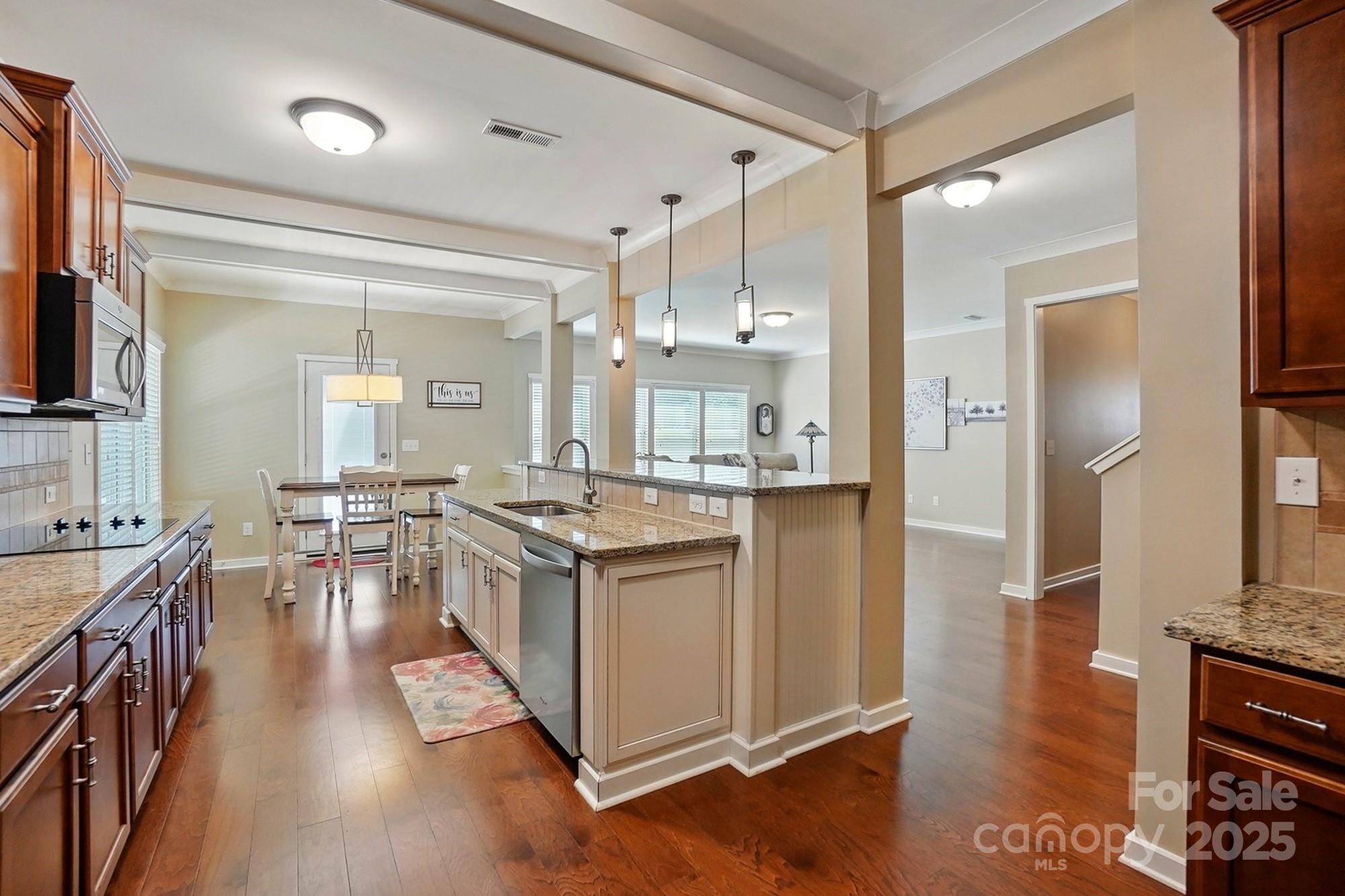 3106 Crosswind Drive Fort Mill, SC 29707 - Photo 6 of 43 a kitchen with kitchen island a counter top space a sink stainless steel appliances and cabinets