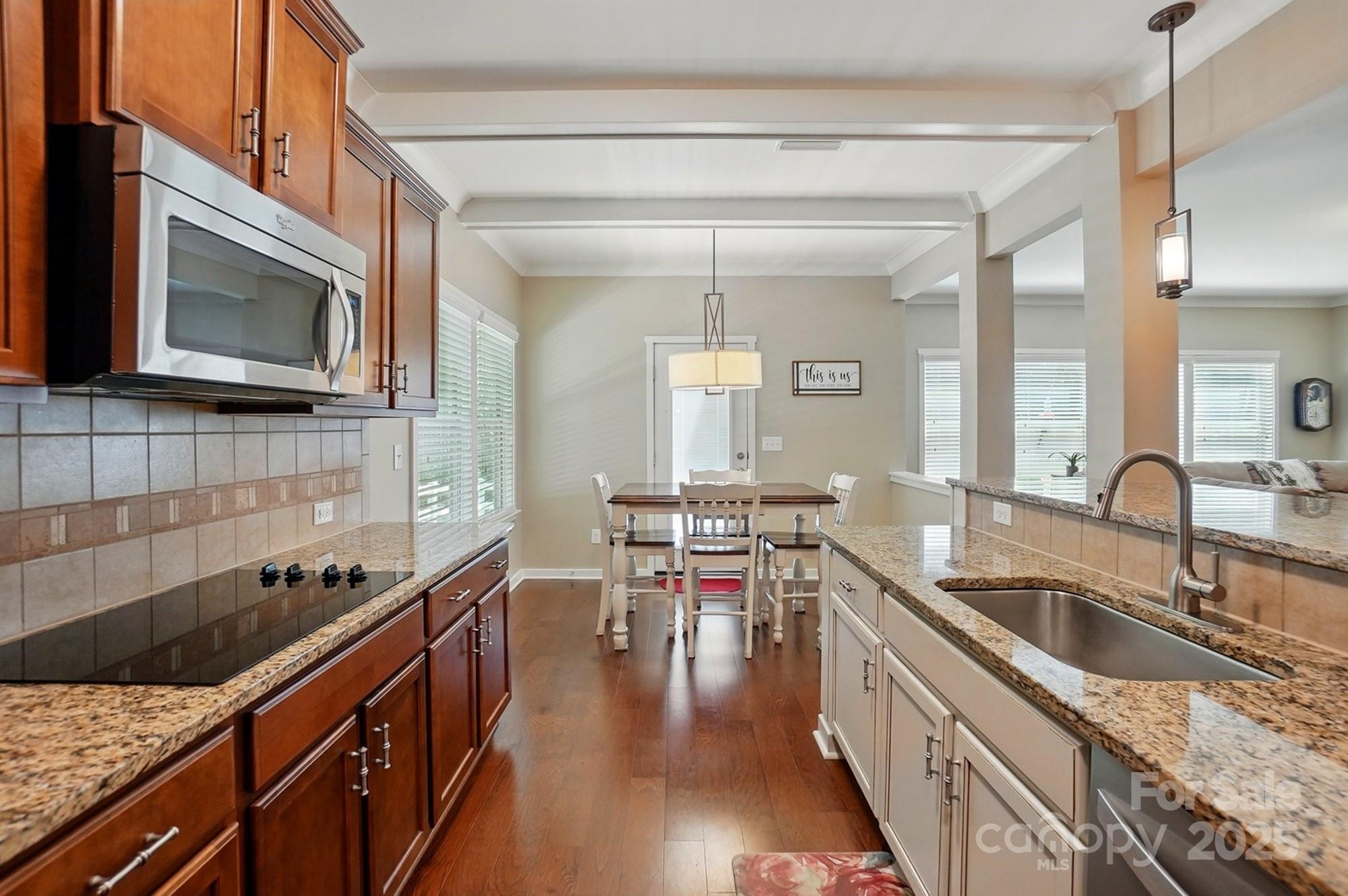 3106 Crosswind Drive Fort Mill, SC 29707 - Photo 7 of 43 a kitchen with stainless steel appliances granite countertop a sink stove and microwave