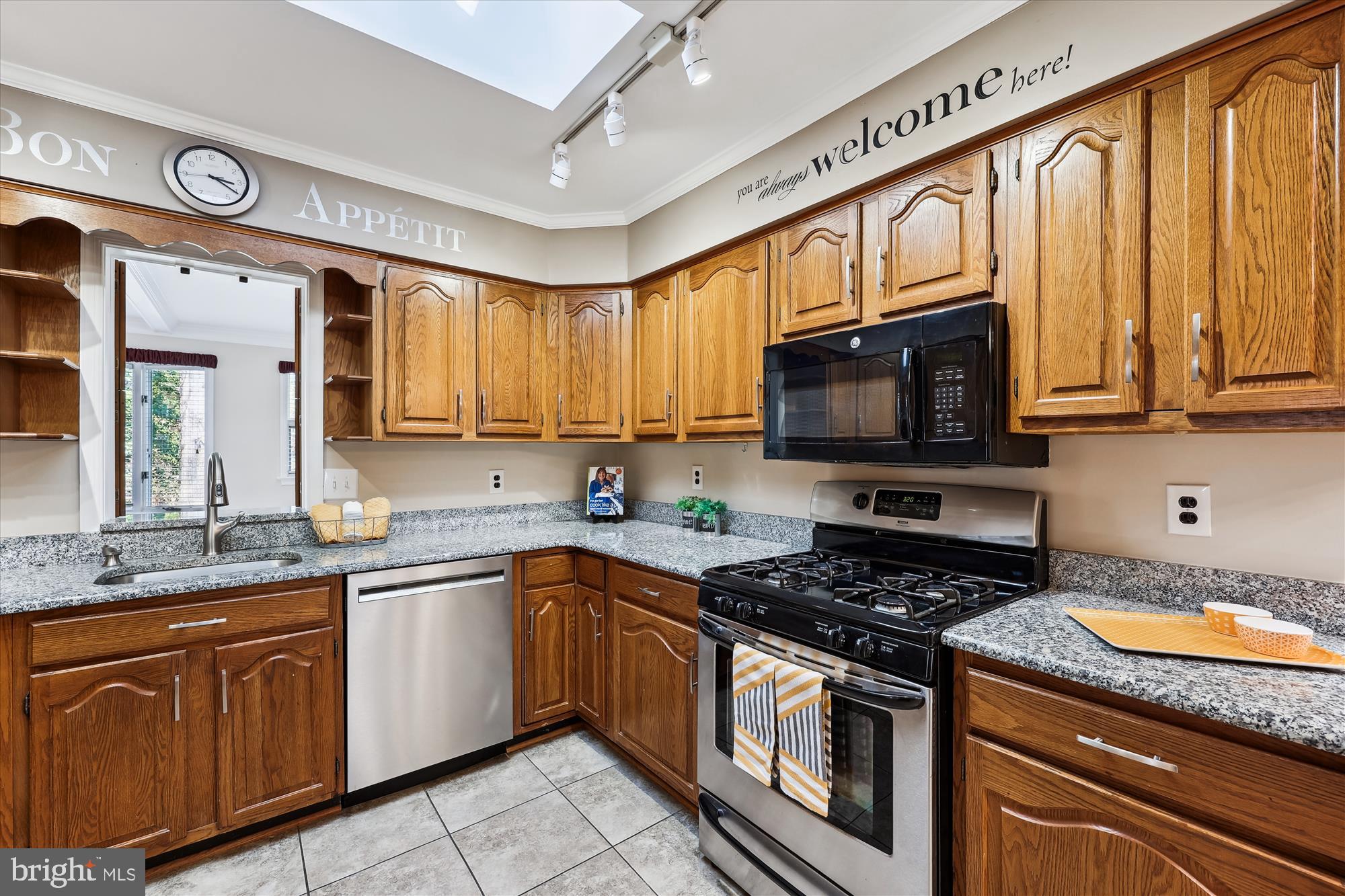 315 Summit Hall Road Gaithersburg, MD 20877 - Photo 30 of 76 a kitchen with stainless steel appliances granite countertop a stove sink microwave and cabinets
