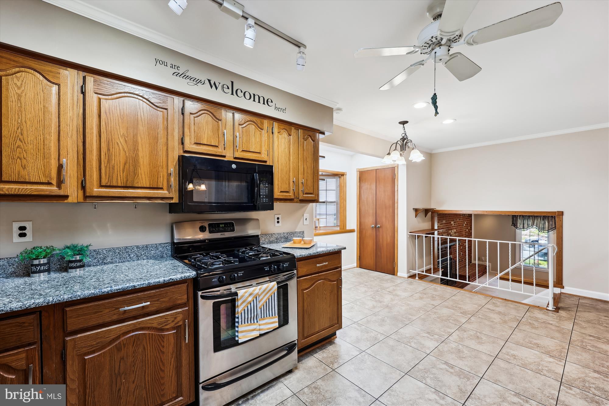315 Summit Hall Road Gaithersburg, MD 20877 - Photo 31 of 76 a kitchen with stainless steel appliances granite countertop a stove top oven a sink dishwasher a dining table and chairs with wooden floor
