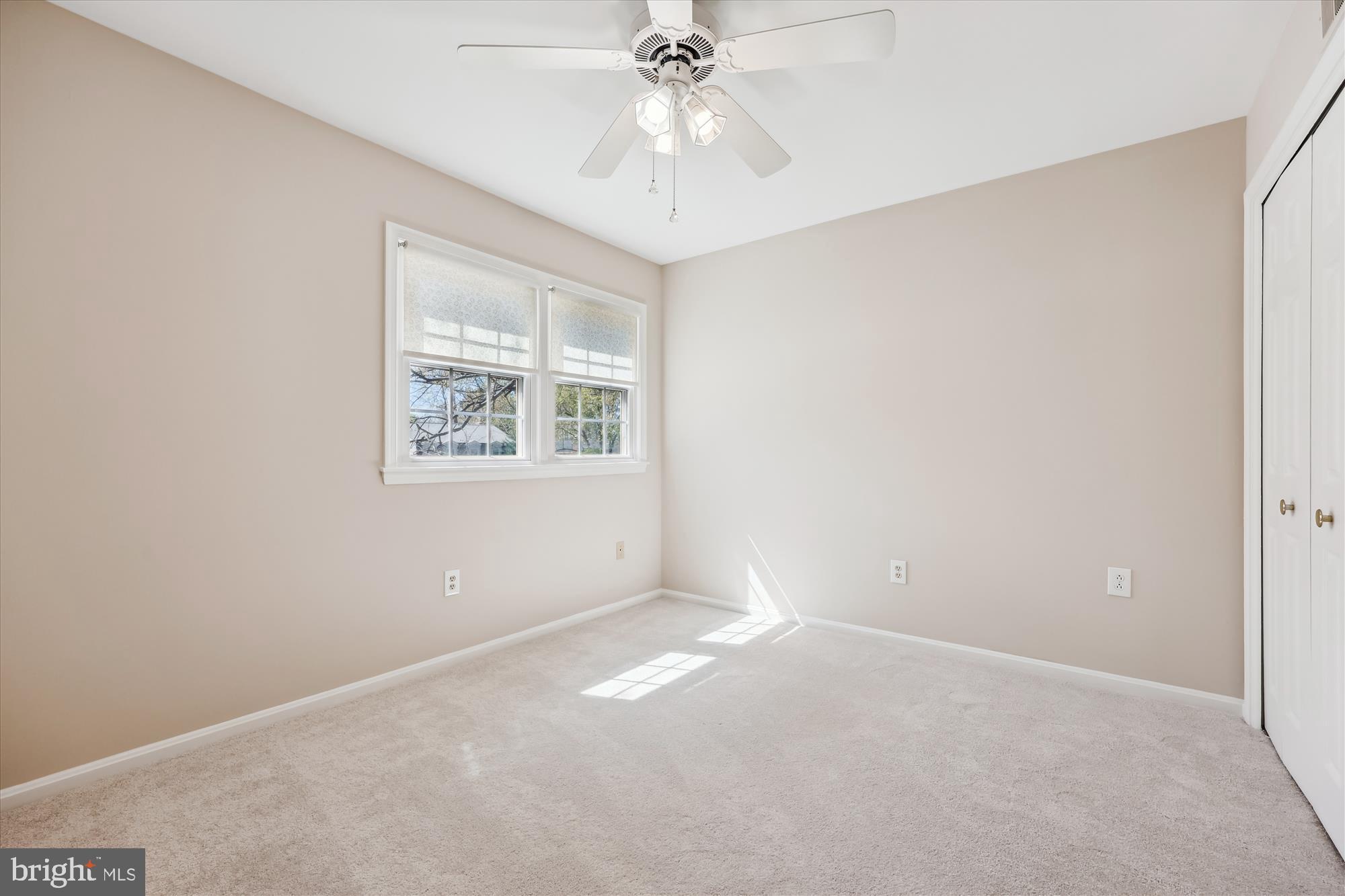 315 Summit Hall Road Gaithersburg, MD 20877 - Photo 46 of 76 an empty room with a chandelier fan and windows