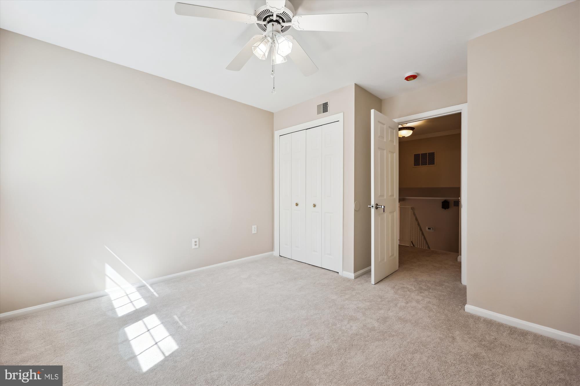 315 Summit Hall Road Gaithersburg, MD 20877 - Photo 48 of 76 an empty room with closet and a chandelier fan