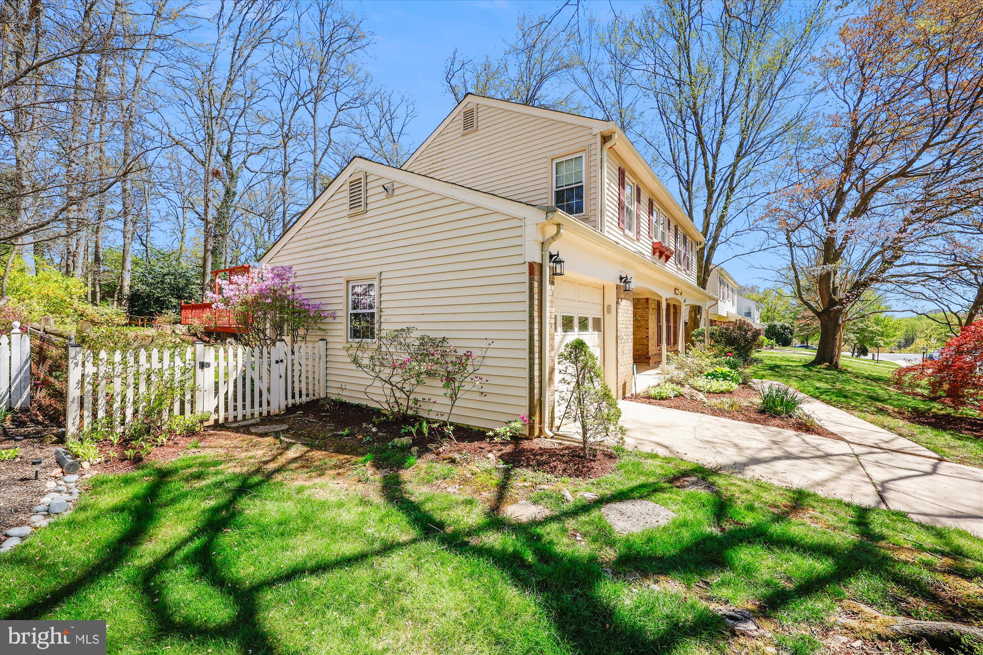 315 Summit Hall Road Gaithersburg, MD 20877 - Photo 74 of 76 a view of a white house with a small yard and large trees