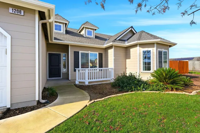 a view of a livingroom with wooden floor and a large window