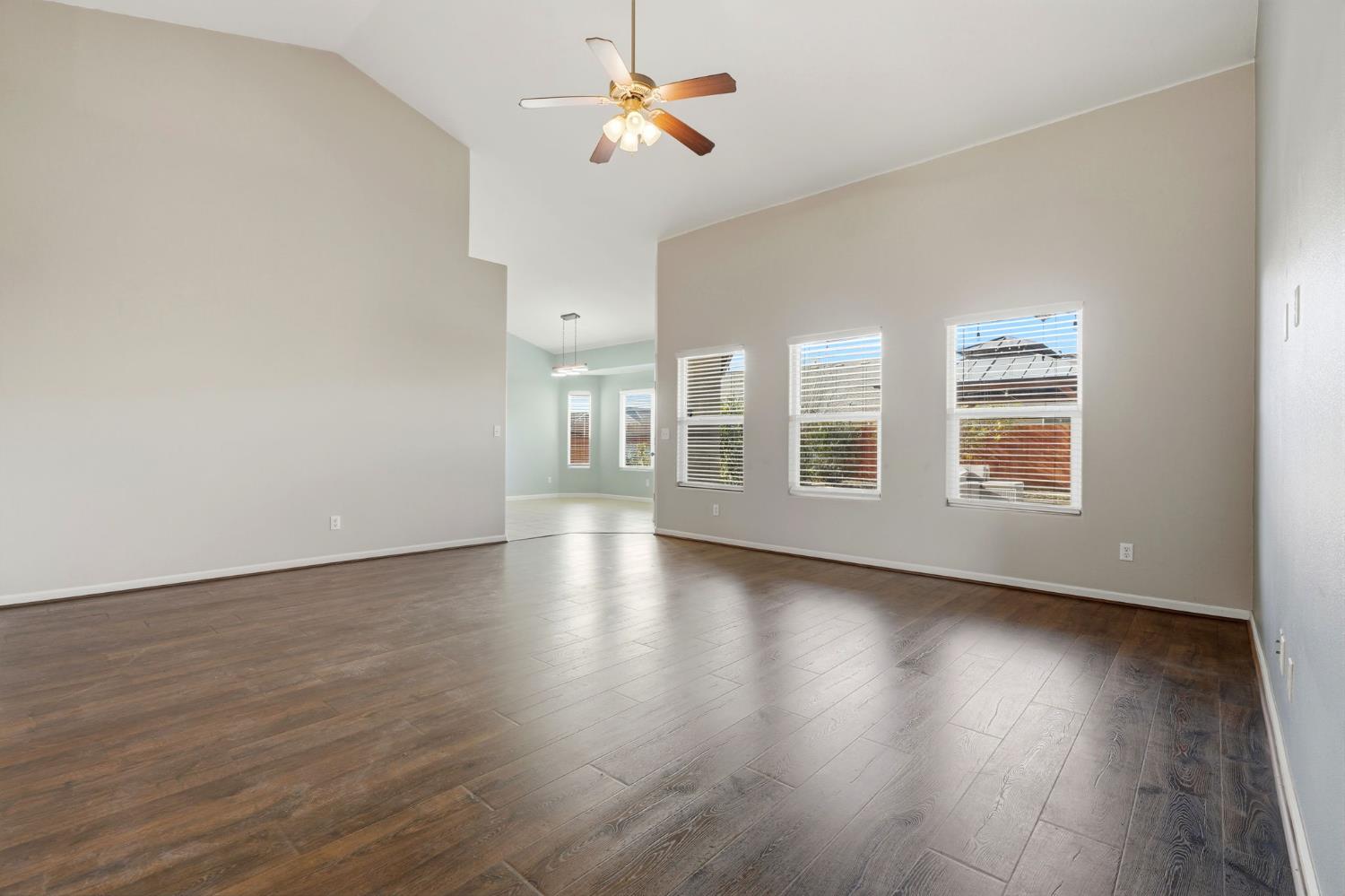 1206 North Kaplan Place Hanford, CA 93230 - Photo 16 of 52 a view of a livingroom with wooden floor and a ceiling fan