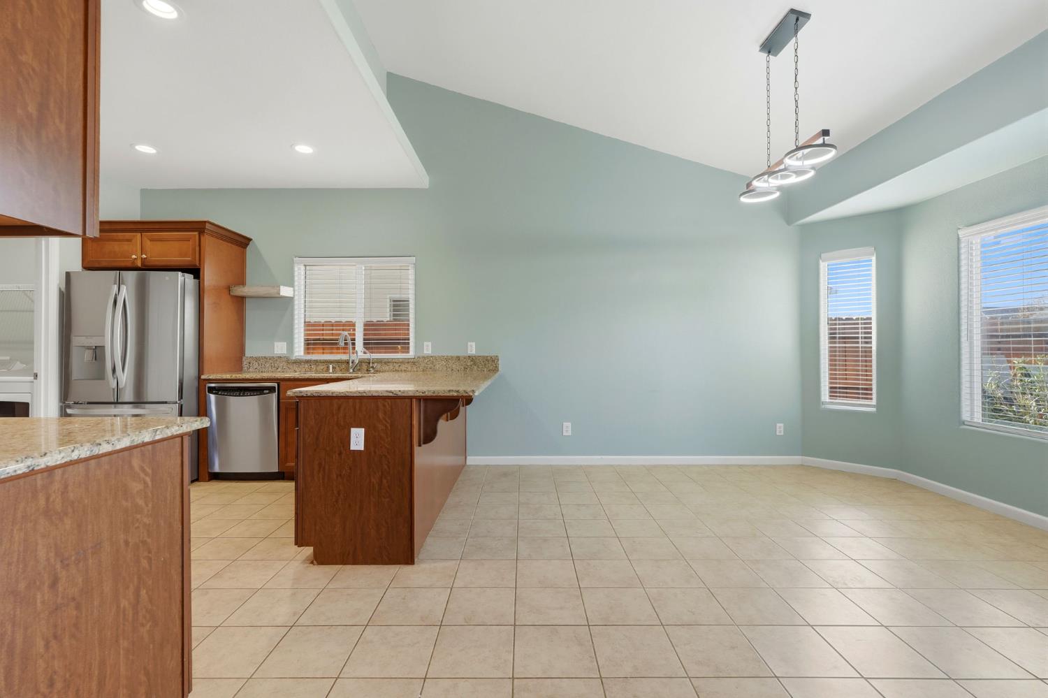 1206 North Kaplan Place Hanford, CA 93230 - Photo 20 of 52 a kitchen with stainless steel appliances granite countertop a sink and a refrigerator