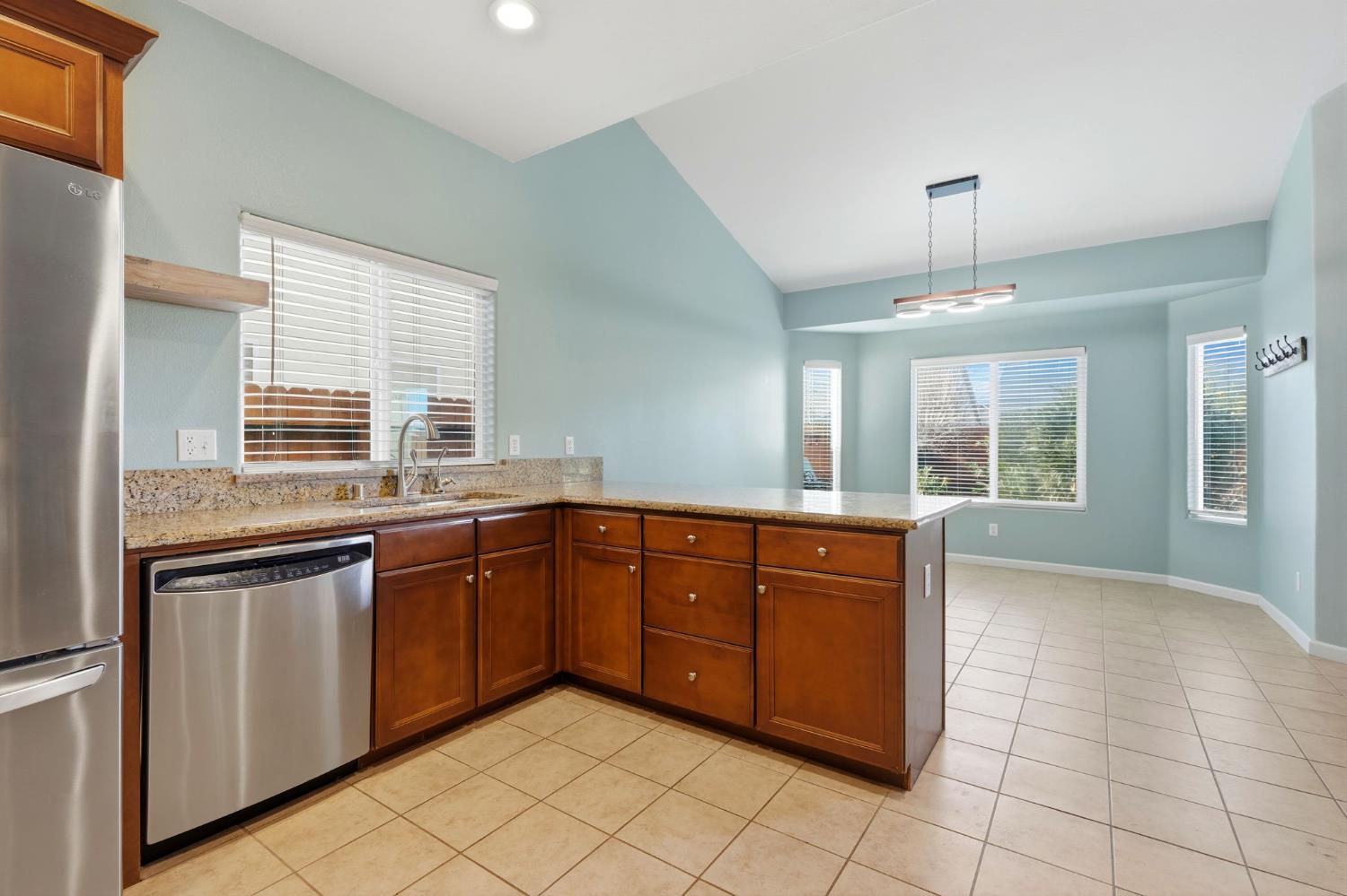 1206 North Kaplan Place Hanford, CA 93230 - Photo 23 of 52 a large kitchen with granite countertop a sink and cabinets