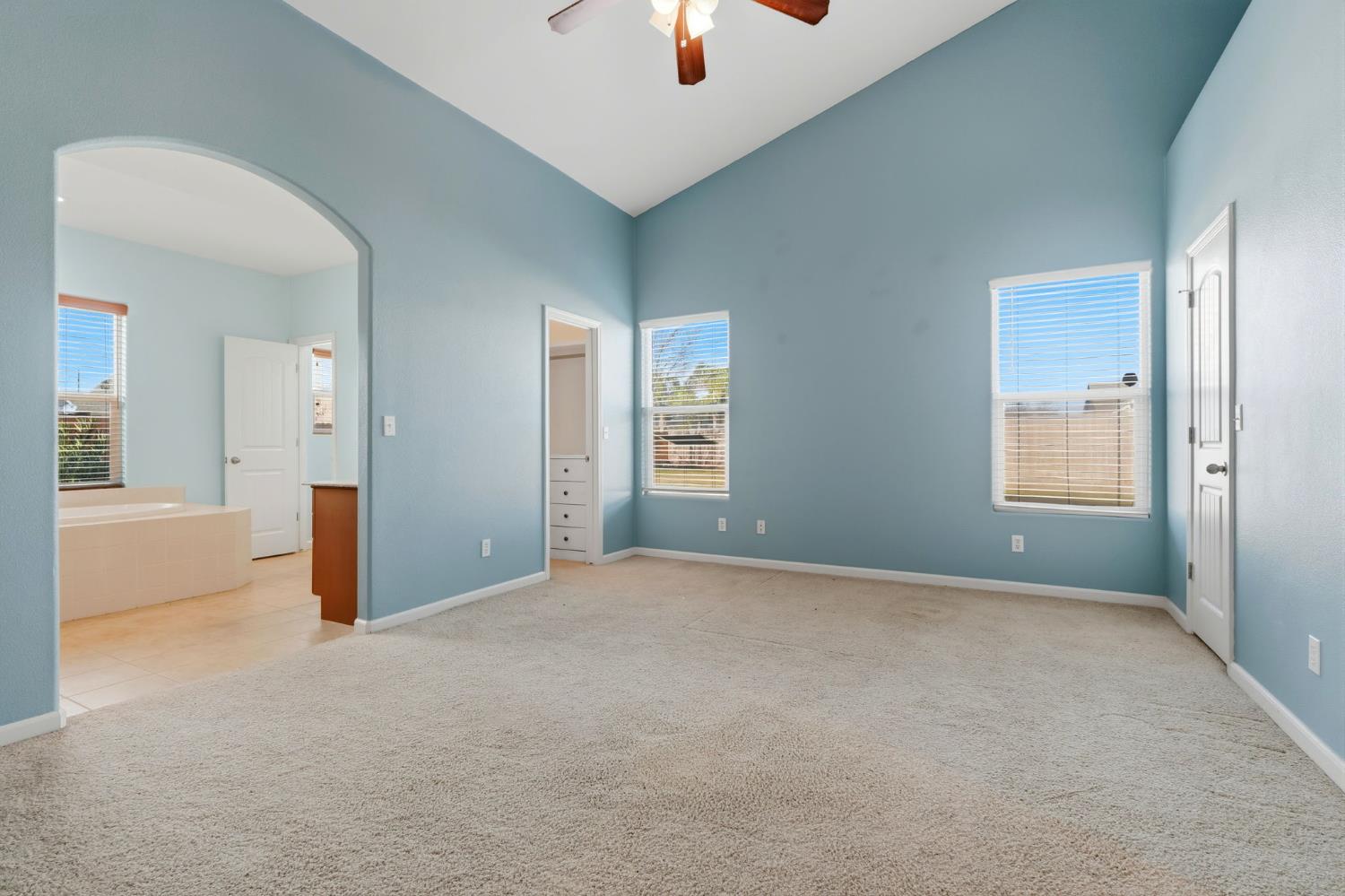 1206 North Kaplan Place Hanford, CA 93230 - Photo 38 of 52 a view of an empty room with chandelier fan and windows