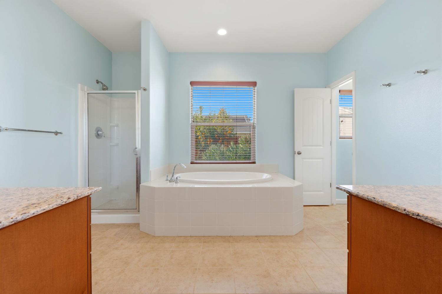 1206 North Kaplan Place Hanford, CA 93230 - Photo 41 of 52 a bathroom with a bathtub and a shower