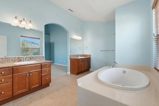 a bathroom with a tub and a sink