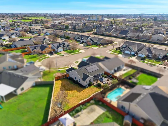 an aerial view of a house with a swimming pool yard and outdoor seating