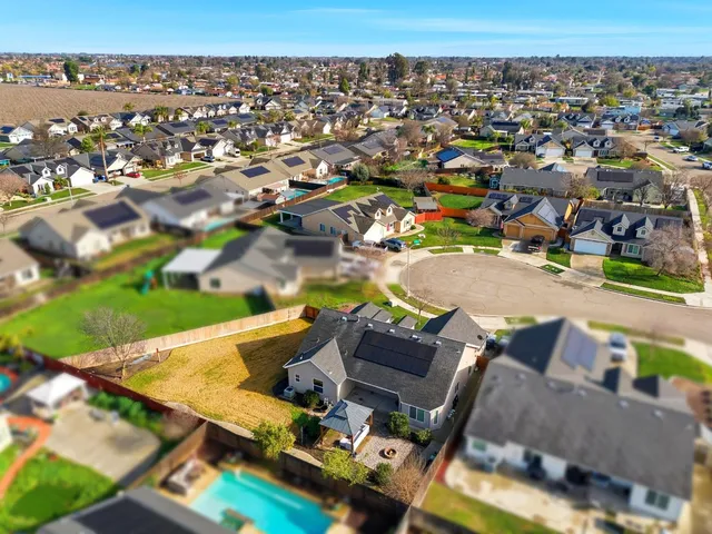 an aerial view of a house with swimming pool