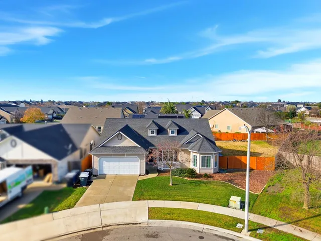 an aerial view of a house with a ocean view