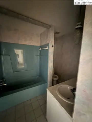 a bathroom with a toilet and a tub