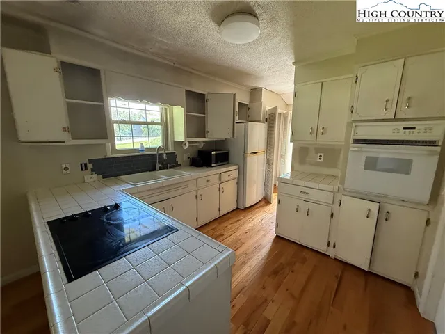 a kitchen with stainless steel appliances a stove a sink and a refrigerator