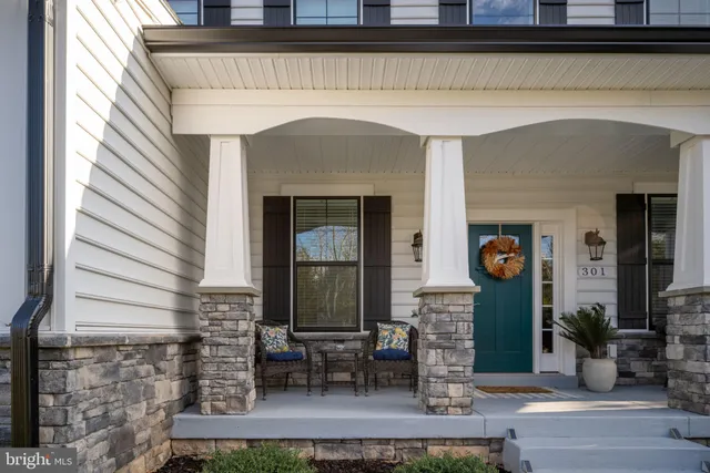 a view of a livingroom with furniture wooden floor and a window