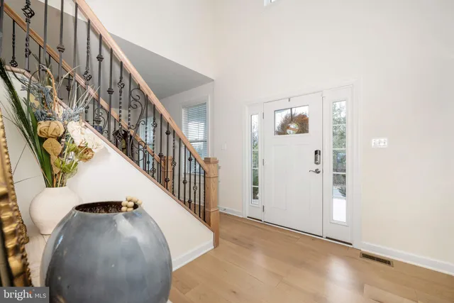 a living room with furniture and a large window with garden view