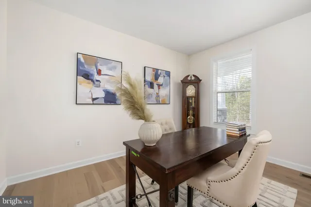 a large white kitchen with a large window and stainless steel appliances