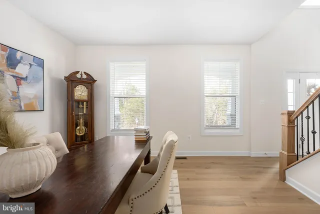 a kitchen with a sink a stove a refrigerator and white cabinets
