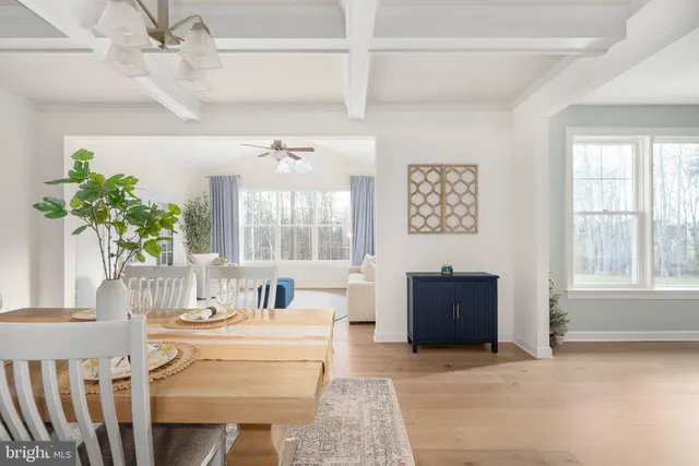 a kitchen with stainless steel appliances white cabinets and a stove top oven