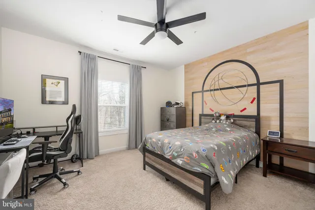 a front view of a house with a yard and potted plants