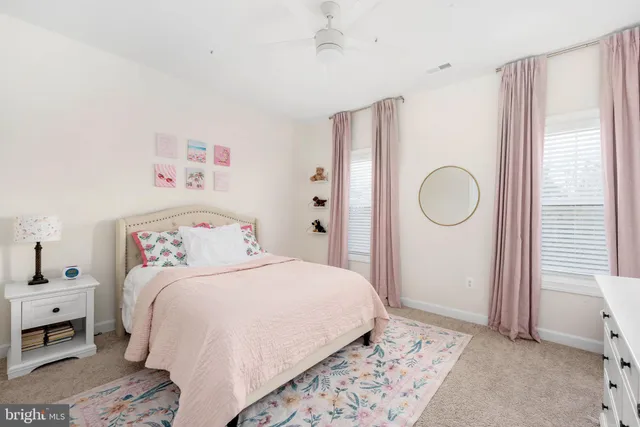 a view of a large swimming pool with a big yard and large trees