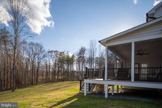 a view of a swimming pool with an outdoor seating and a yard