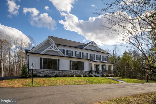 a front view of a house with a yard table and chairs