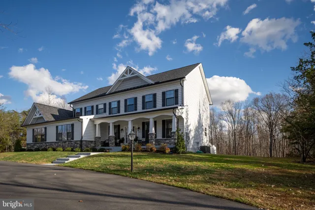 a front view of a house with a yard table and chairs