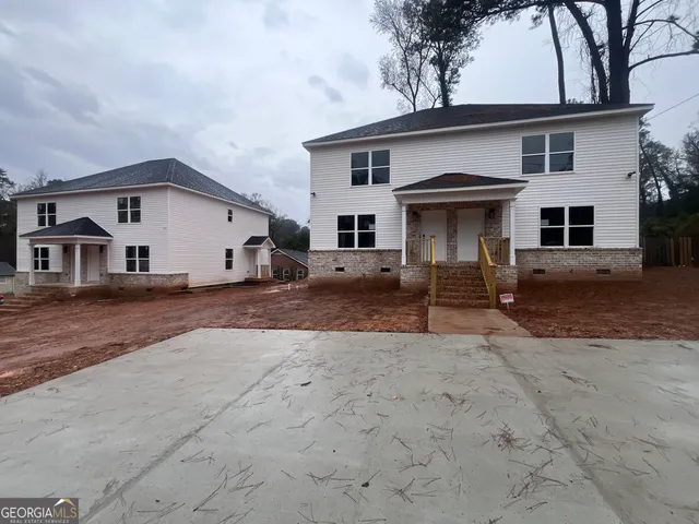 an empty room with fan and windows