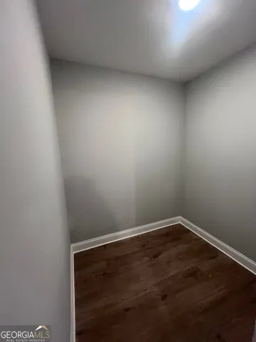 a bathroom with a granite countertop sink mirror vanity and toilet